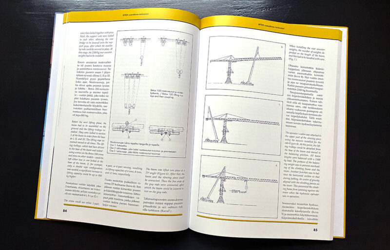 Kirjan aukeama jolla tekstiä sekä torninosturipiirustuksia.